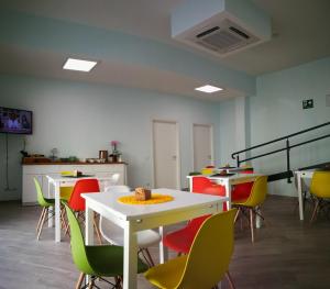 a room with tables and chairs with a cake on top at La Formica in Civitavecchia