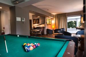 a room with a pool table in a hotel room at Residence Acqua del Conte in Messina