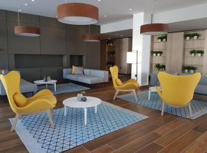 a living room filled with furniture and a table at Hotel Park Plava Laguna in Poreč