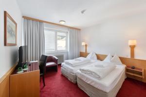 En eller flere senger på et rom på Am Neutor Hotel Salzburg Zentrum