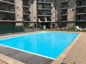 a swimming pool in front of an apartment building at Le Grand Panorama No11 in Saint-Gervais-les-Bains