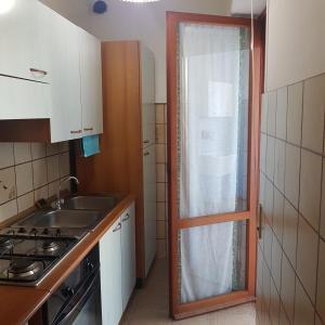 a small kitchen with a sink and a window at allery in Alba Adriatica