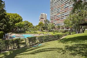 um parque com piscina e um edifício alto em Coqueto Apartmento con vistas al mar em Alicante