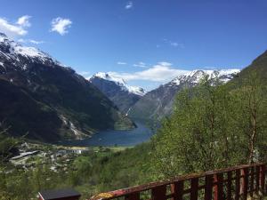 a view of a lake in a valley with mountains at Solbakken Cabins in Geiranger