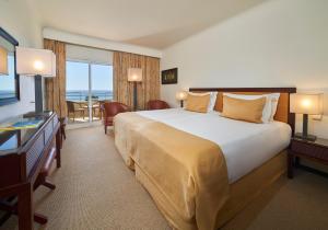 a hotel room with a large bed and a television at PortoBay Falesia in Albufeira +37 photos