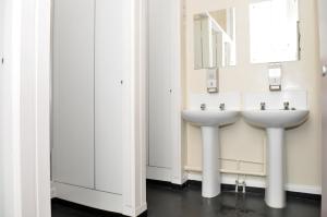 a bathroom with two sinks and a mirror at The Hostel in Edinburgh +27 photos