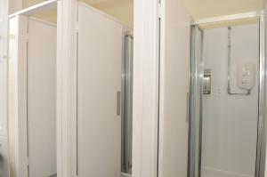 a bathroom with a glass door and a mirror at The Hostel in Edinburgh