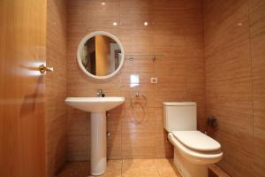 a bathroom with a toilet and a sink and a mirror at Pont de Toneta 4,1 Ransol, Zona Grandvalira in Ransol +3 photos