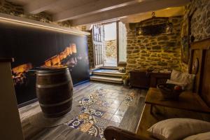 a room with a barrel and a stone wall at Casa Rural El Portillo in Cantavieja