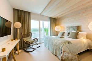 a bedroom with a bed and a desk and a window at Hôtel restaurant Spa de l'Abbaye in Grande Riviere