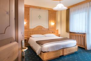 Postel nebo postele na pokoji v ubytování Hotel Astoria
