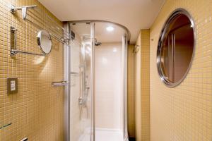 a bathroom with a shower and a mirror at the b akasaka in Tokyo