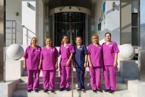 a group of women in pink scrubs standing in front of a building at Hotel Isabel in Torremolinos