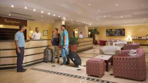 men standing in a room with luggage at Bel Air Azur Resort (Adults Only) in Hurghada