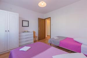 a bedroom with two beds and a dresser at vila lokvanj in Ližnjan +60 photos