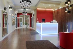 a lobby of a store with red walls and a chandelier at Hotel Ajax in Janki