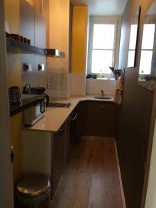 a small kitchen with a sink and a counter at Bakia in Biarritz +7 photos