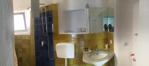 a bathroom with a sink and a toilet in it at I 5 PASSI in Filicudi