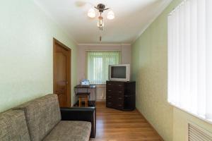 a living room with a couch and a television at Apart-Comfort Kyoto in Yaroslavl