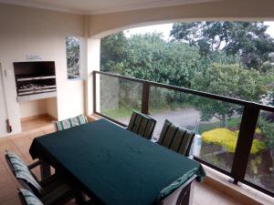 a dining room with a table and chairs and a large window at The Shores, Ramsgate in Ramsgate