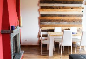 a dining room with a table and white chairs at The Lodge in San Siro