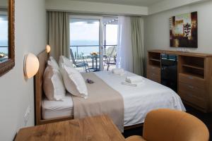 a hotel room with a bed and a balcony at Villa Lukić in Makarska +61 photos