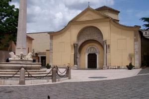 a church with a fountain in front of a building at Janara - Santa Sofia in Benevento