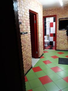 a hallway with a tile floor and a room with a toilet at Апартаменты двухкомнатные in Kansk