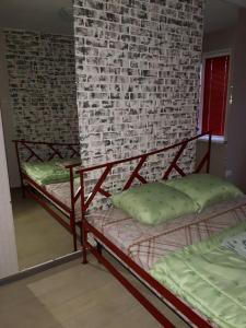 two bunk beds in a room with a brick wall at Апартаменты двухкомнатные in Kansk