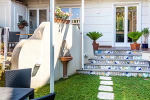 a home with a staircase with green grass at Hotel Mignon Meublè in Sorrento