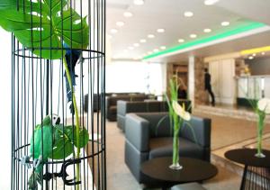 a bird in a bird cage in a lobby at AVIA Hotel in Regensburg