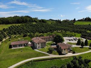 Vue aérienne d'une maison sur un champ verdoyant dans l'établissement Relais Montemarino, à Borgomale