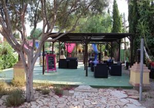a pavilion with tables and chairs in a park at Finca Doña Sofia Maria in San Pedro del Pinatar