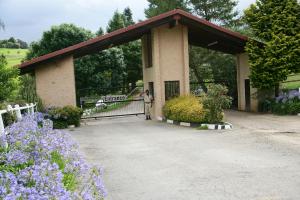 a pavilion with a woman standing in front of it at First Group Midlands Saddle and Trout in Mooirivier