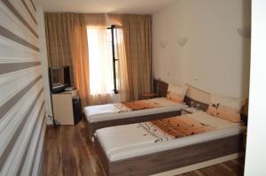 Postel nebo postele na pokoji v ubytování Eos Hotel