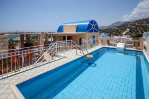 a swimming pool on the roof of a building at Porto Plakias & Spa in Plakias