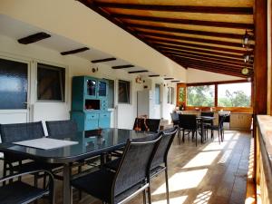 a dining room with a table and chairs at Casa Veche Corbeni in Corbeni