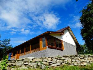 a house with a stone wall at Casa Veche Corbeni in Corbeni
