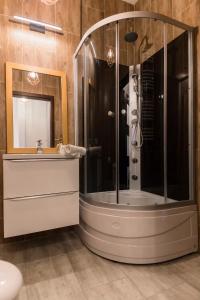 a bathroom with a shower and a sink at GoldenEye Apartment Center in Wrocław