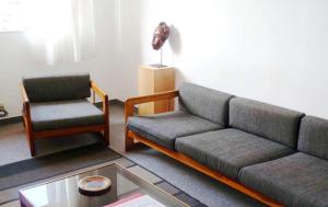 a living room with a couch and a chair at Résidence Bertille Abidjan Cocody in Abidjan