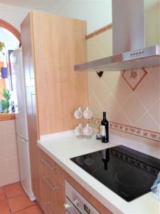 a kitchen with a counter with a sink and a refrigerator at Casa Herminia in Frigiliana +59 photos