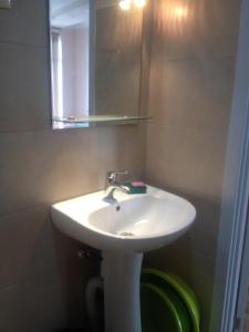 a bathroom with a white sink and a mirror at Nodari in Batumi +52 photos