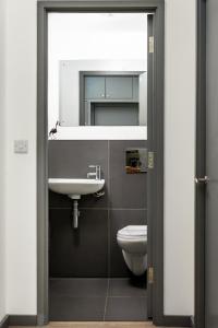 a bathroom with a sink and a toilet at Lancing beach apartment. in Lancing