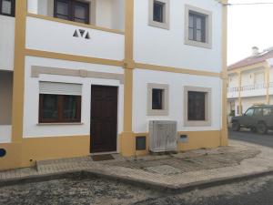 a white and yellow building with a door at Studio do Brejo - de 2 a 3 pessoas in Vila Nova de Milfontes