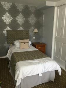 A bed or beds in a room at The Haymaker Inn 