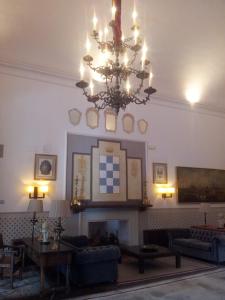 a living room filled with furniture and a fireplace at Parador de Oropesa in Oropesa