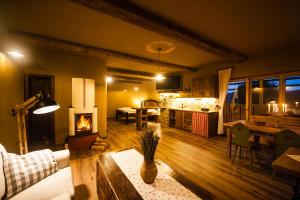 a living room with a fireplace and a kitchen at Lavender Hill, Eko Resort & Wellness in Polzela