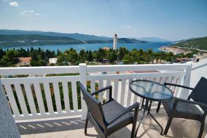 a balcony with a table and chairs and a view of the water at Villa Doris in Neum