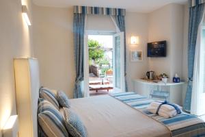 a bedroom with a bed and a door to a patio at Villa Carlotta Minori in Minori