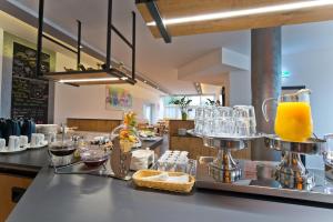 a kitchen with a counter with a bar with orange juice at City Hotel in Chemnitz